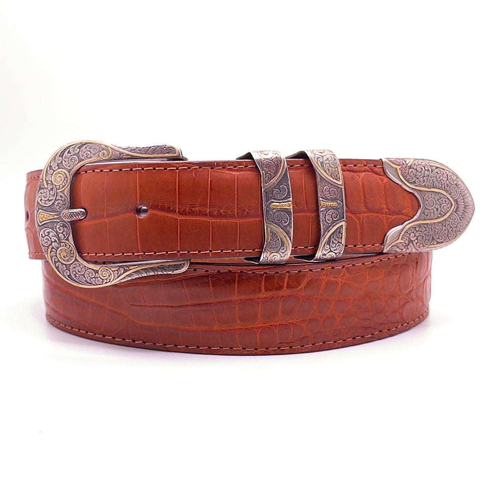 Neil Hunt Blue Dominion belt buckle set shown on a cognac Nile crocodile belt strap.