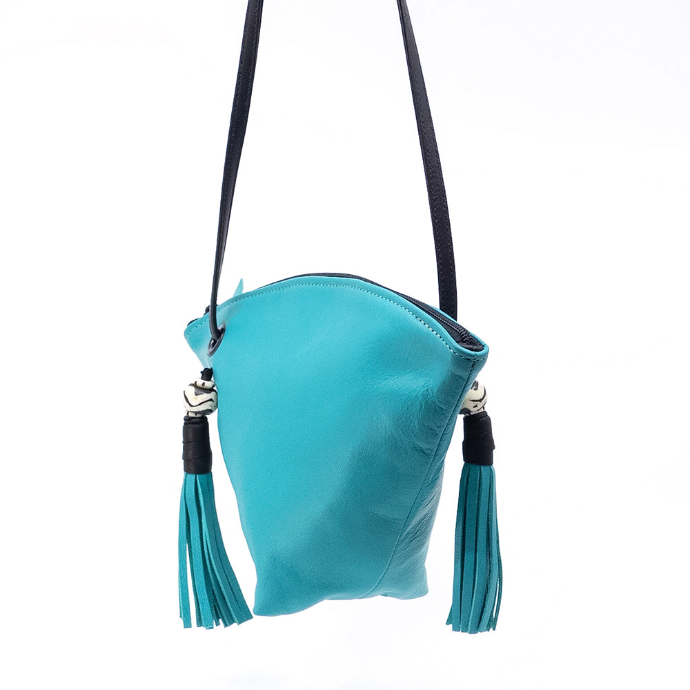 Side view of a the jade leather Fortune Cookie crossbody bag.