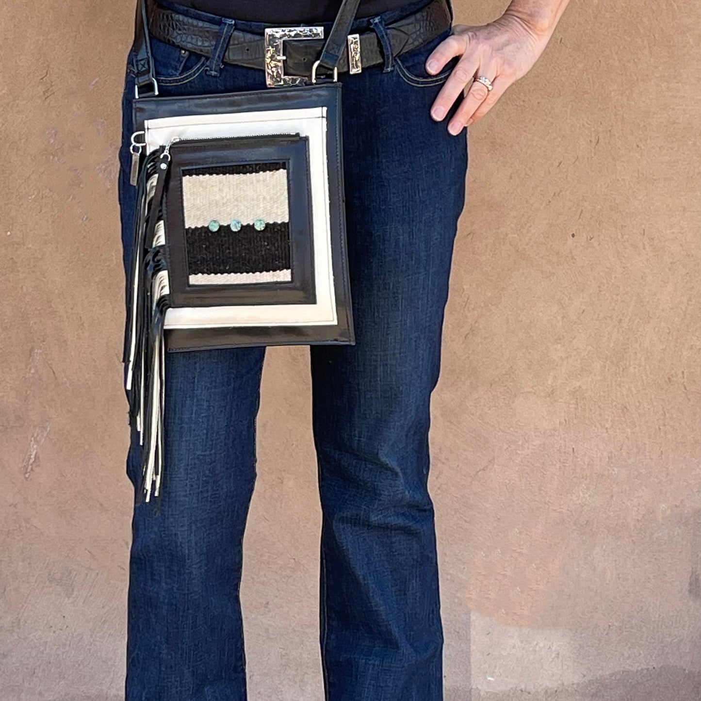 Woman holding a Badolera crossbody bag.
