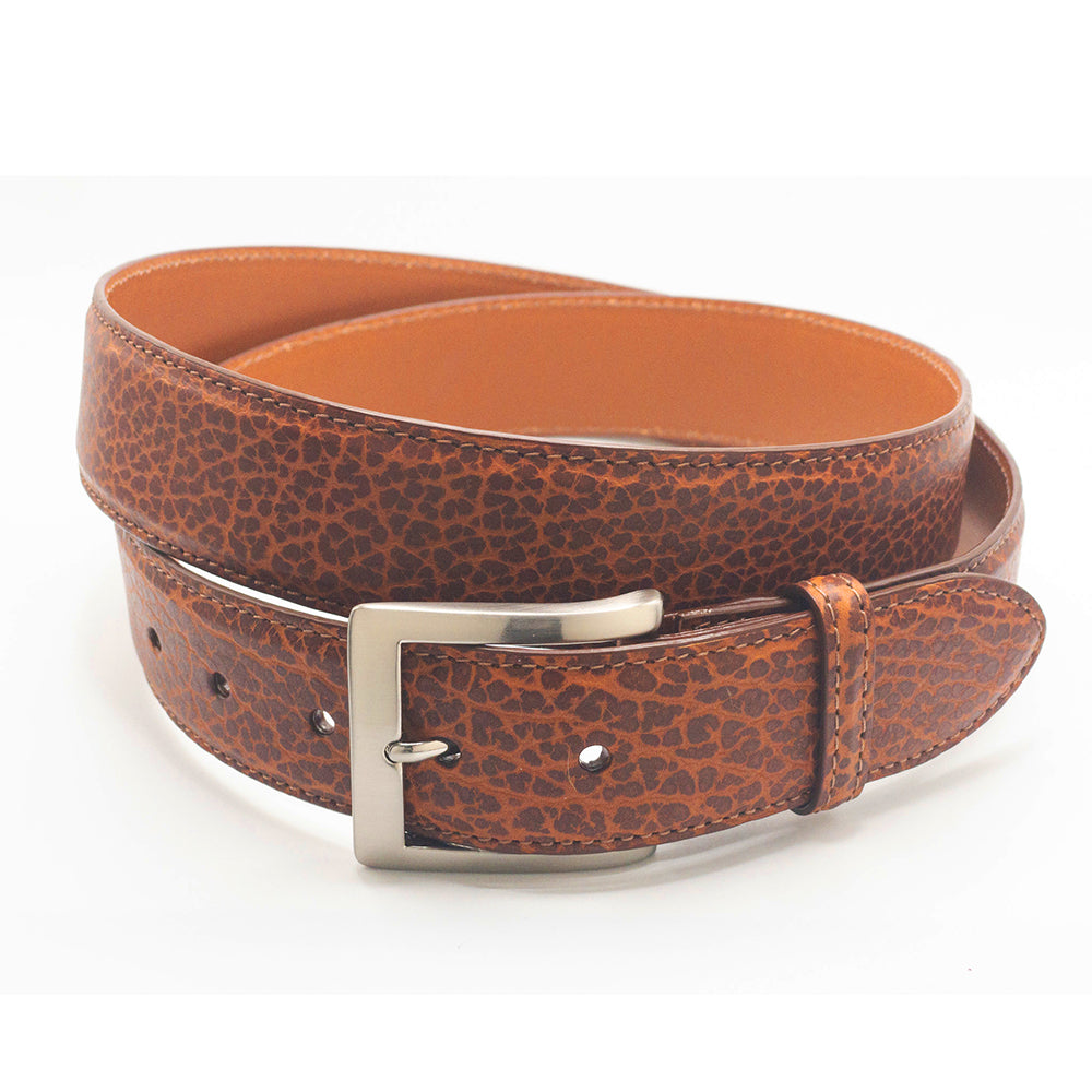 Cognac bison leather belt with a silver buckle on a white background