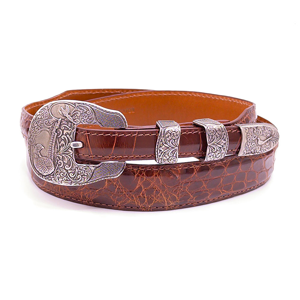 Neil Hunt Dakota Days belt buckle set shoun on a cognac alligator belt strap.