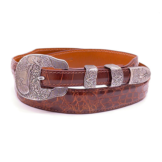 Neil Hunt Dakota Days belt buckle set shoun on a cognac alligator belt strap.