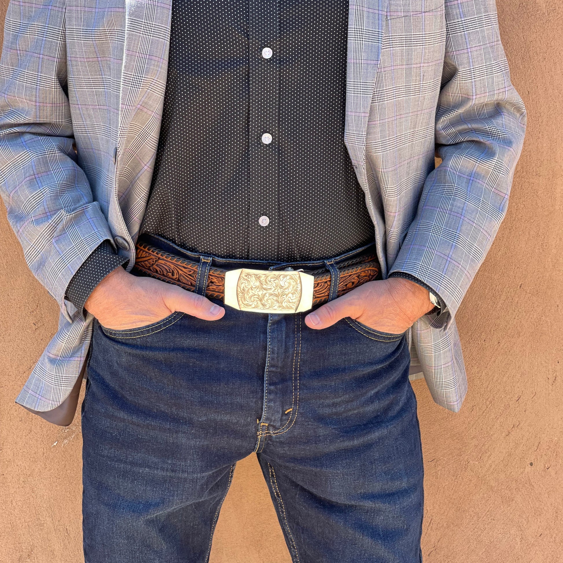 Waist view of man wearing Denver belt buckle.