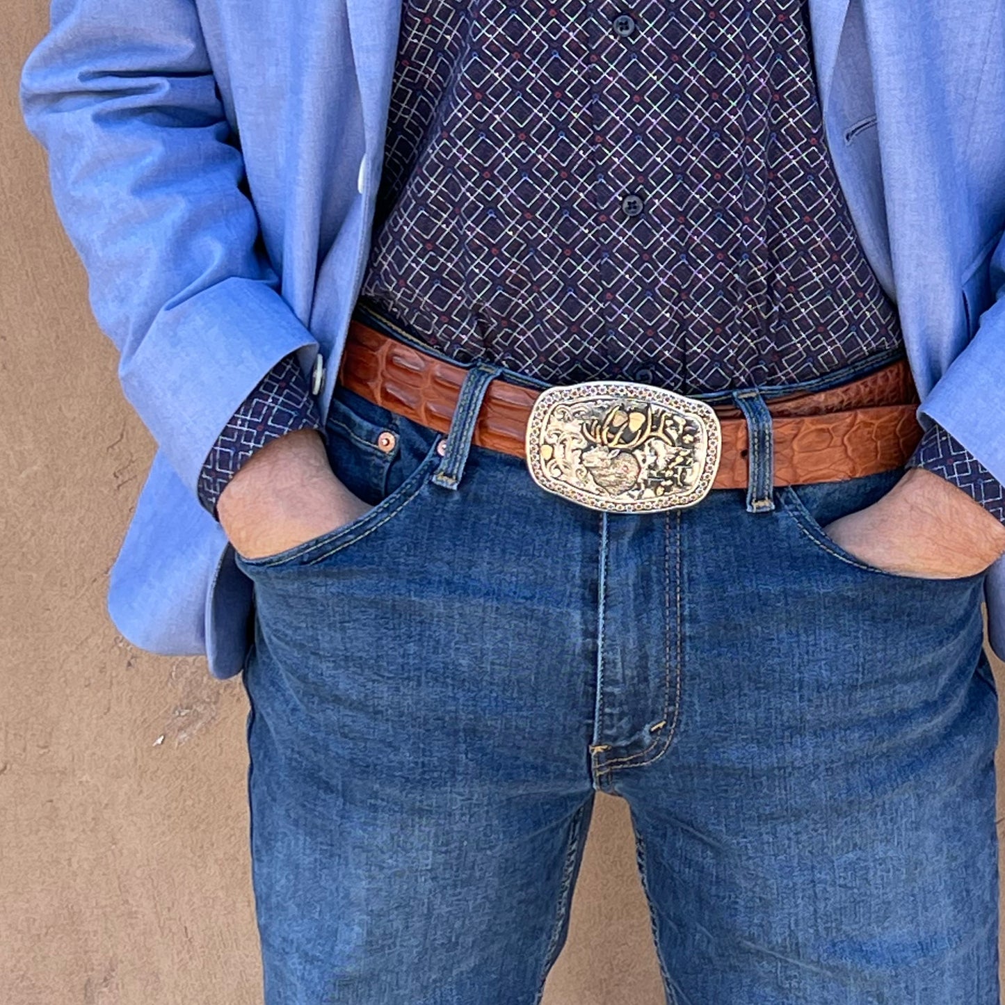 Waist view of man wearing Elk Trophy belt buckle.