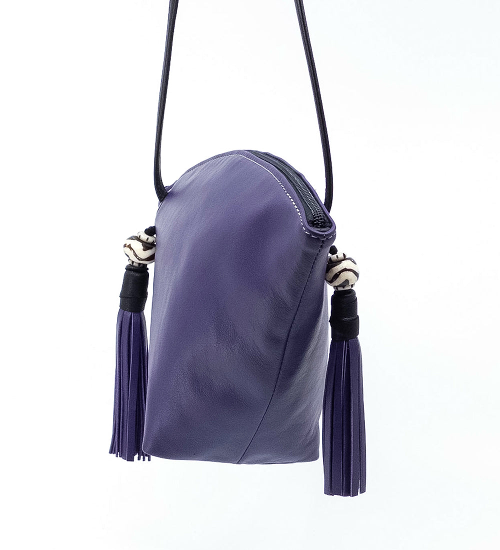 Side view off the purple Fortune Cookie crossbody bag.