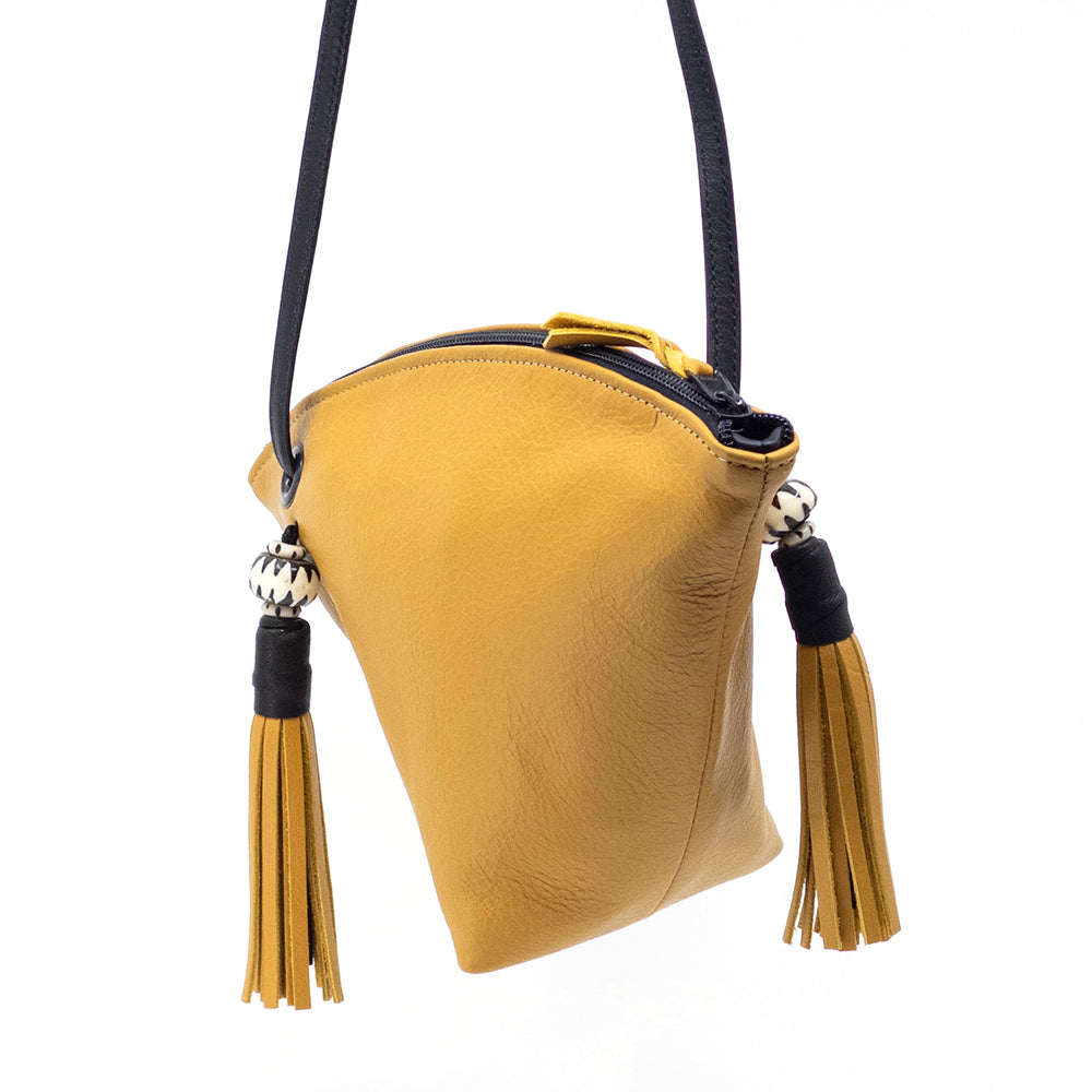 Sice view of the gold leather Fortune Cookie crossbody bag.