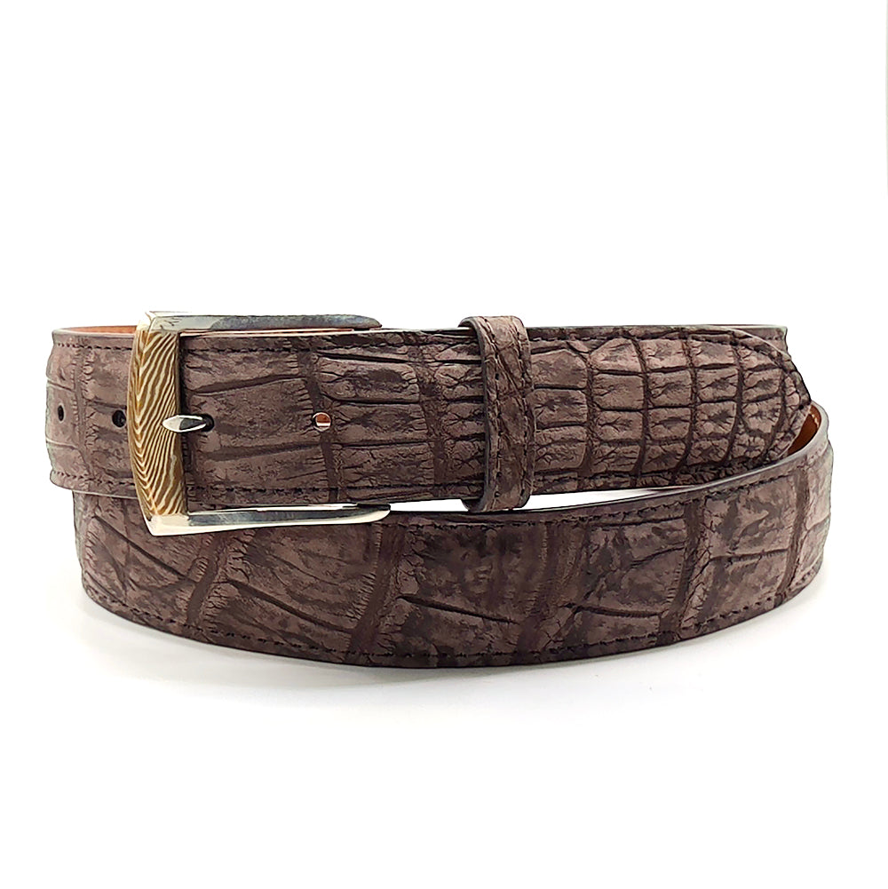 Neil Hunt Mokume-Gane buckle on a brown suede alligator belt strap.