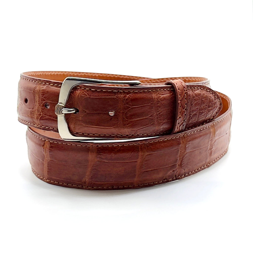 Neil Hunt Mokume-Gane buckle on a matte cognac alligator belt strap. 