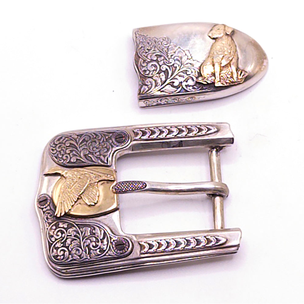 Decorative belt buckle with intricate designs on a white background