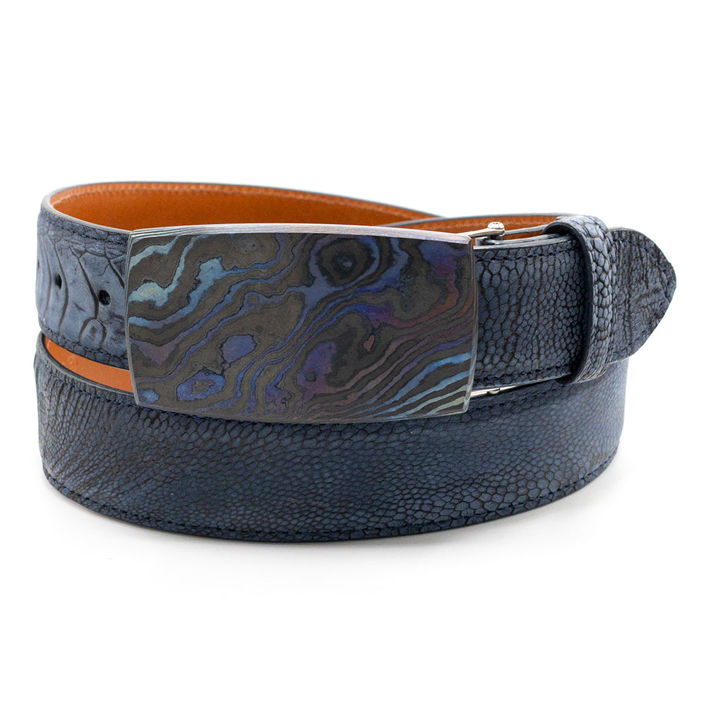 Pat Pruitt Space Cowboy belt buckle shown on a navy blue ostrcih leg blet strap.