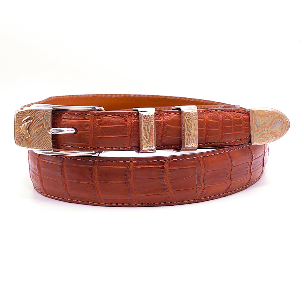 Neil Hunt Prairie Wind with Gold Quail buckle set shown on a cognac Nile crocodile belt strap.