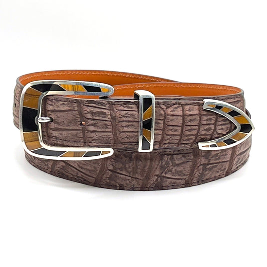 Chacon Caliente with tigereye and onyx inlay shown on a brown suede allgator belt.